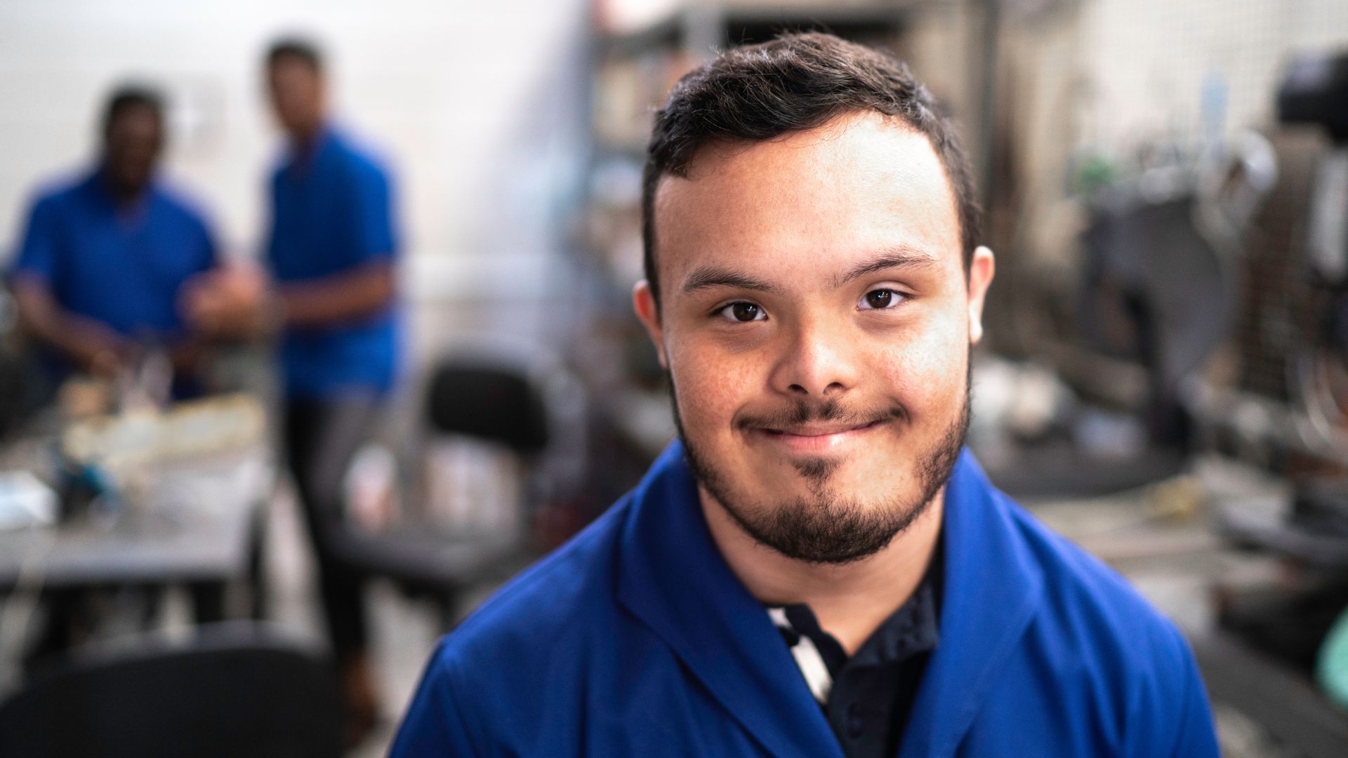 A man smiles as he works from a warehouse