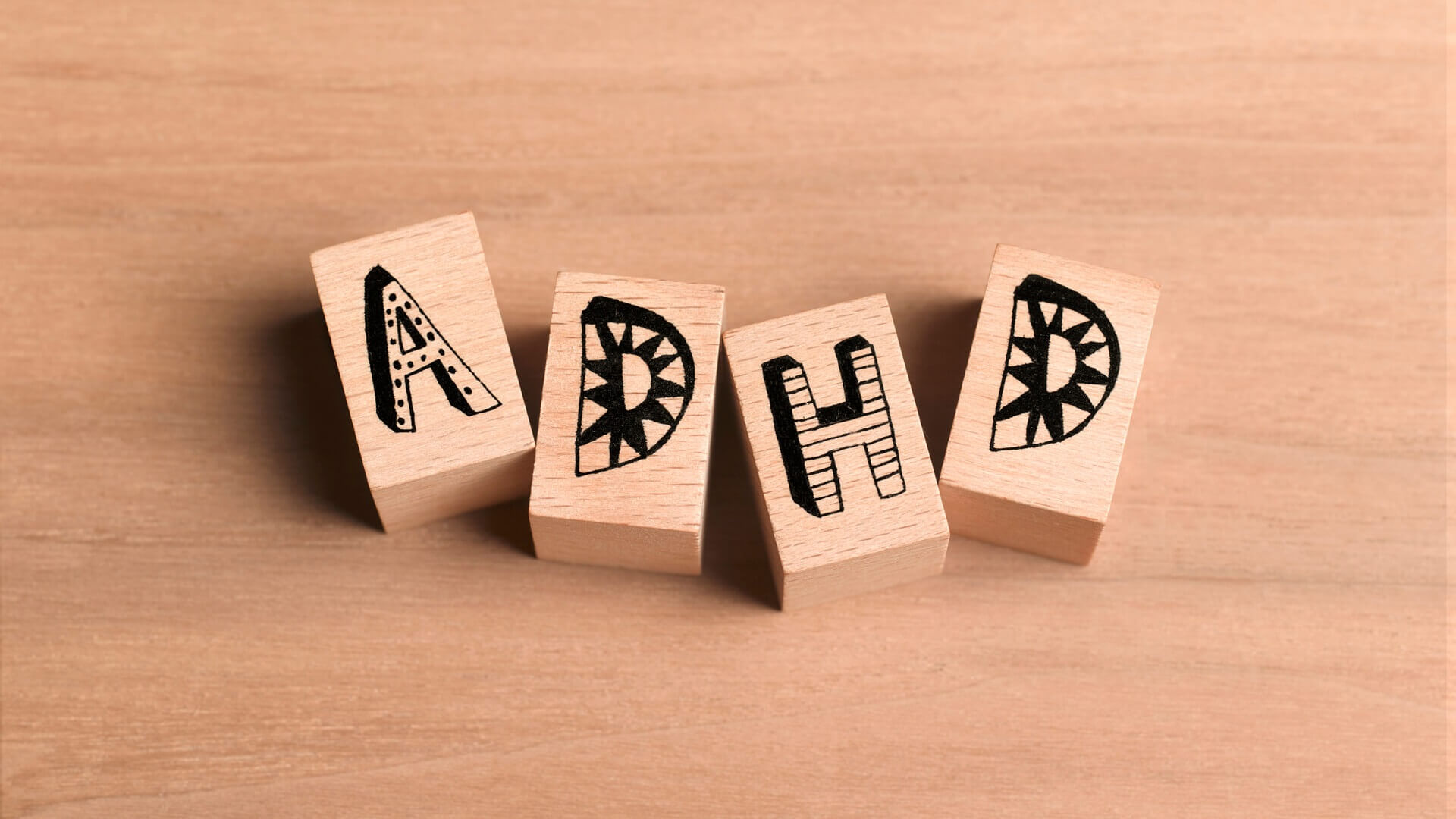 Four wooden blocks spelling out ADHD