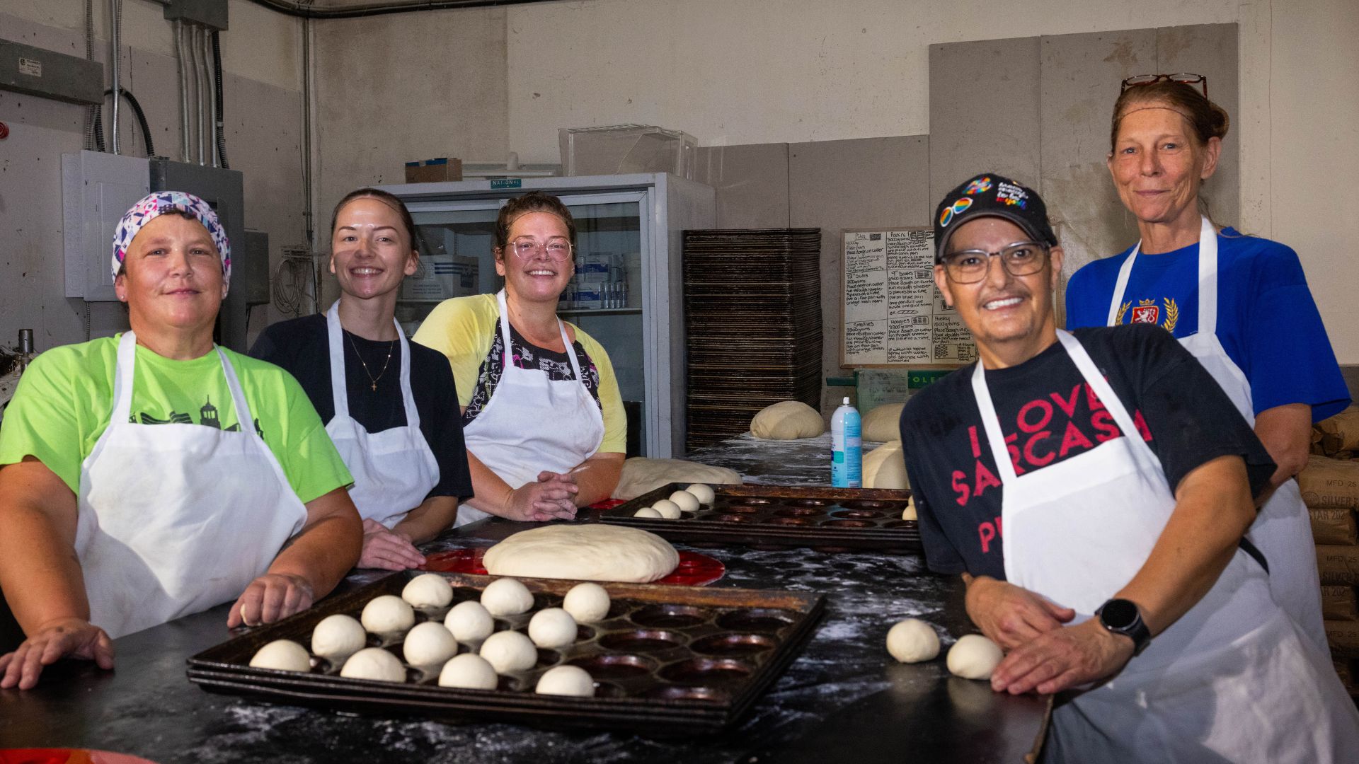 Leigh works alongside colleagues at a bakery, preparing dough and baked goods. The supportive workplace helped Leigh build confidence and achieve employment through WorkBC's Bakery Assistant Program.