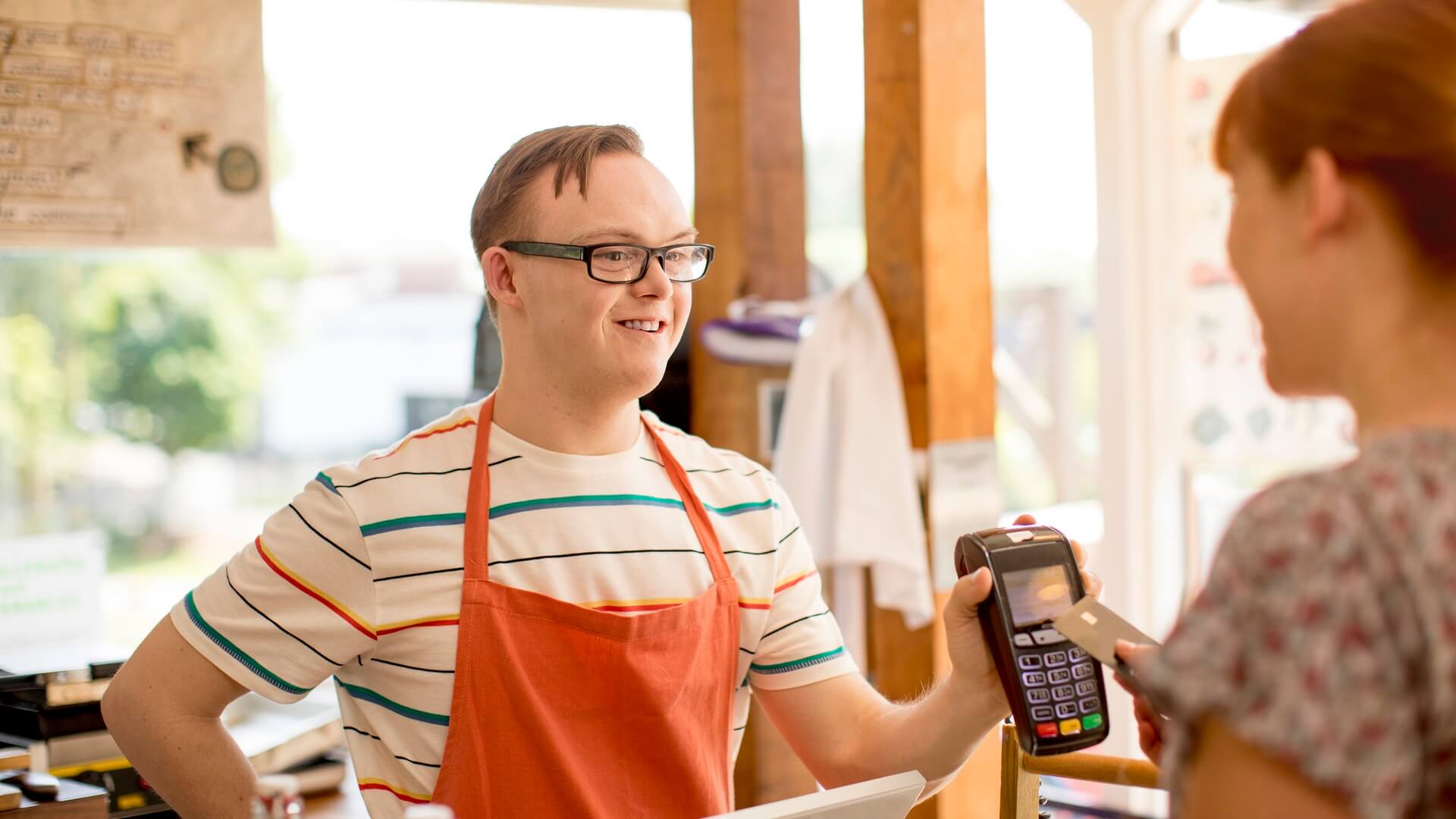 A man serving a customer in a café