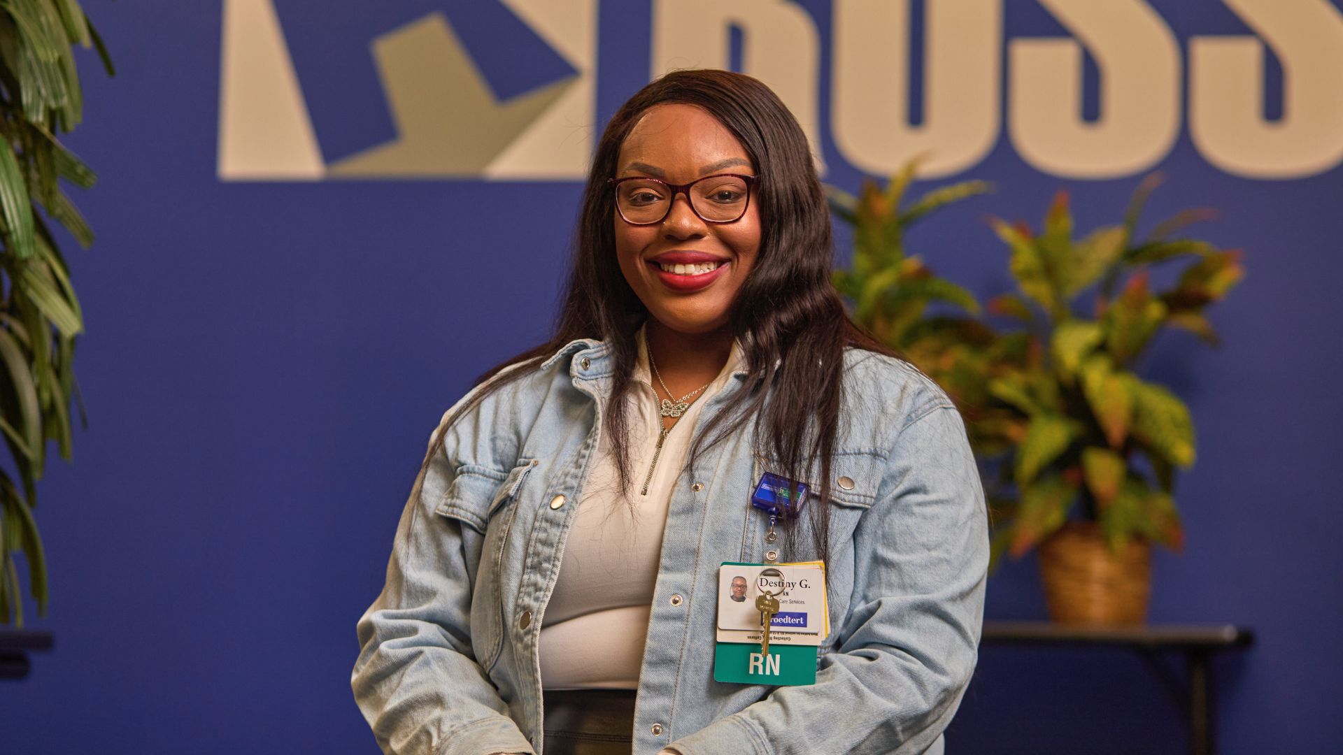 Destiny proudly shows her registered nurse badge after completing her degree and achieving her goal.