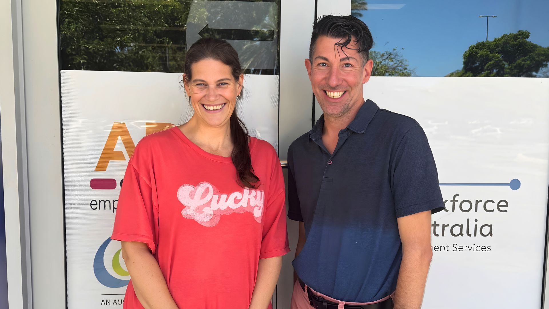 EST participant Tarlia standing with Michael from APM Employment Services outside an employment services office