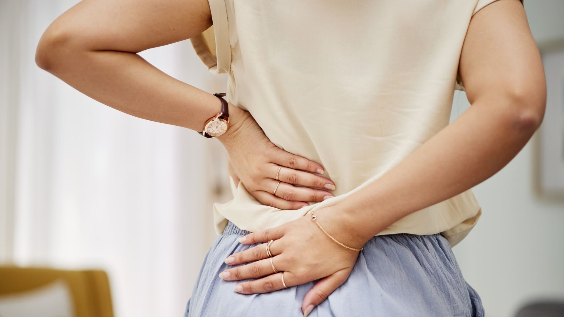 A woman touching her painful back
