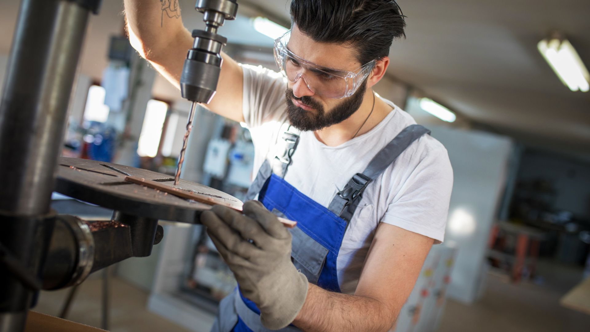 A man operates a drill