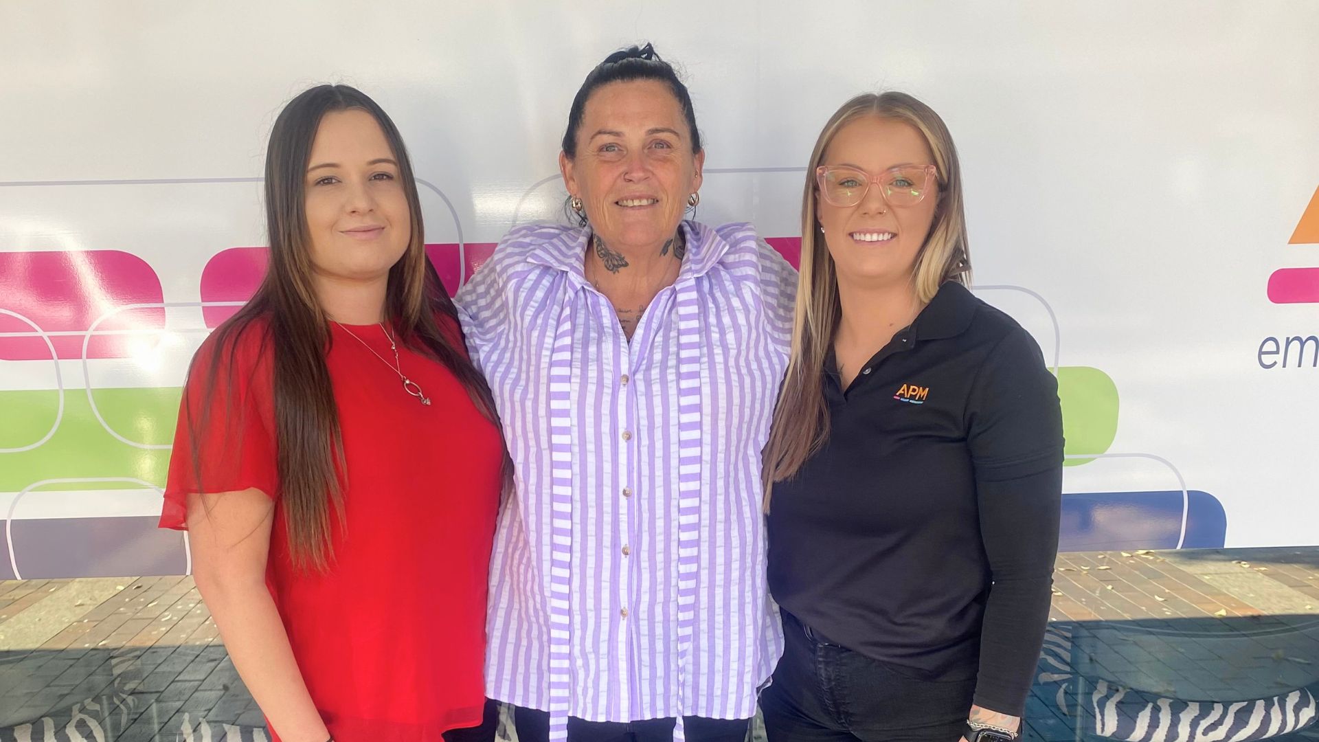 Karen stands with APM Employment Consultant Jessi and APM Business Manager Courtney after finding work as an aged care support worker through Inclusive Employment Australia.