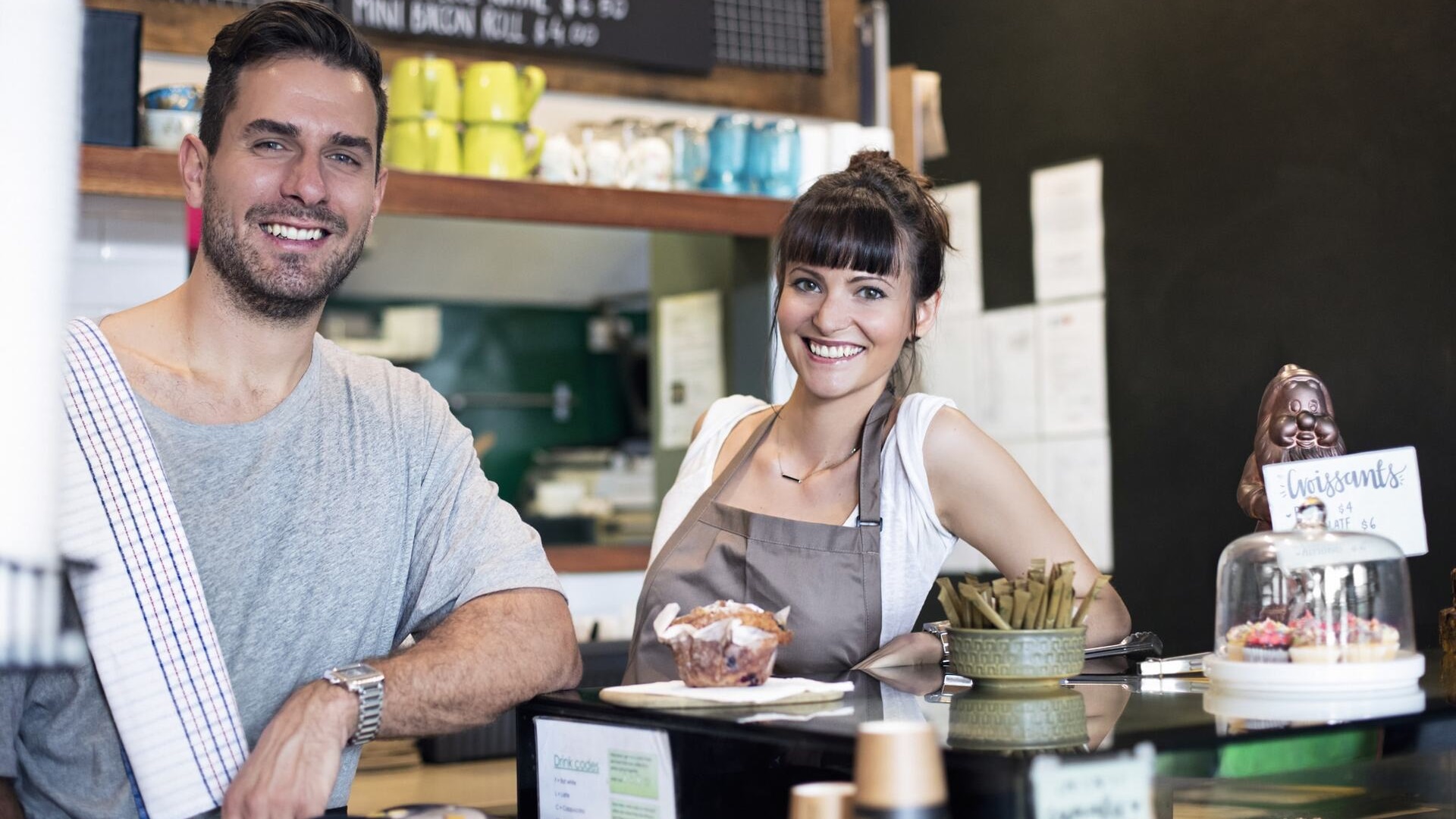 Two cafe workers standing at the front counter