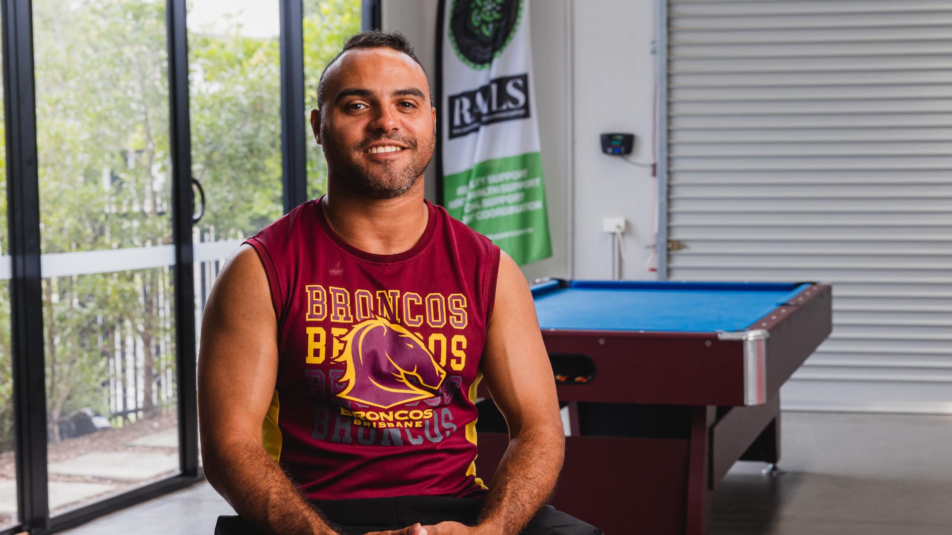 Young First Nations man in a sports club smiling