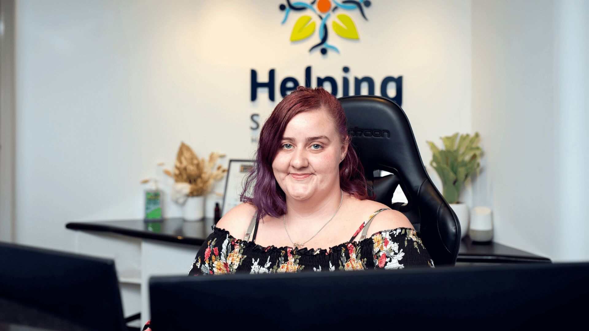 DES Participant Kristie sitting at a computer smiling