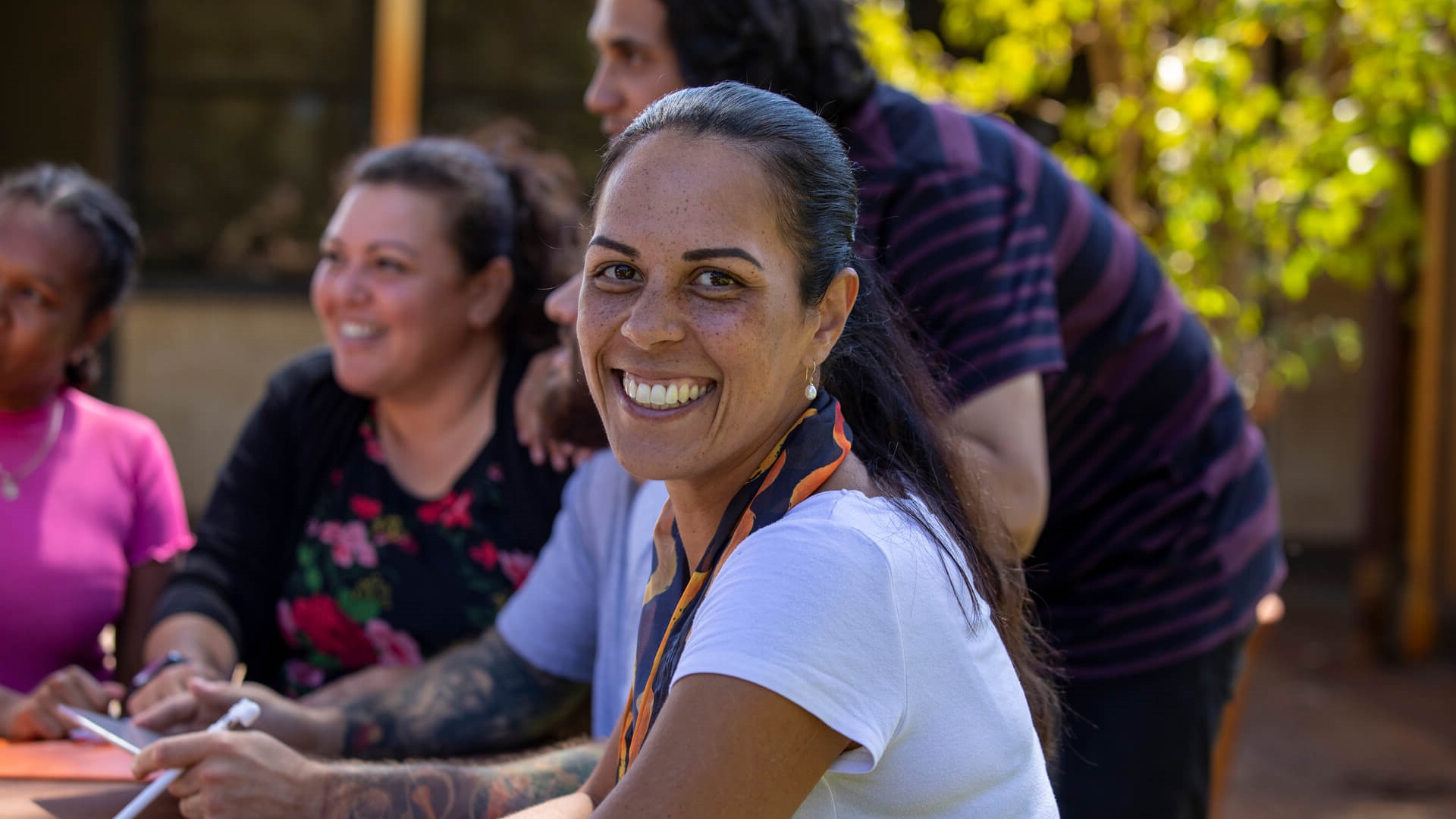 A woman smiling outdoors