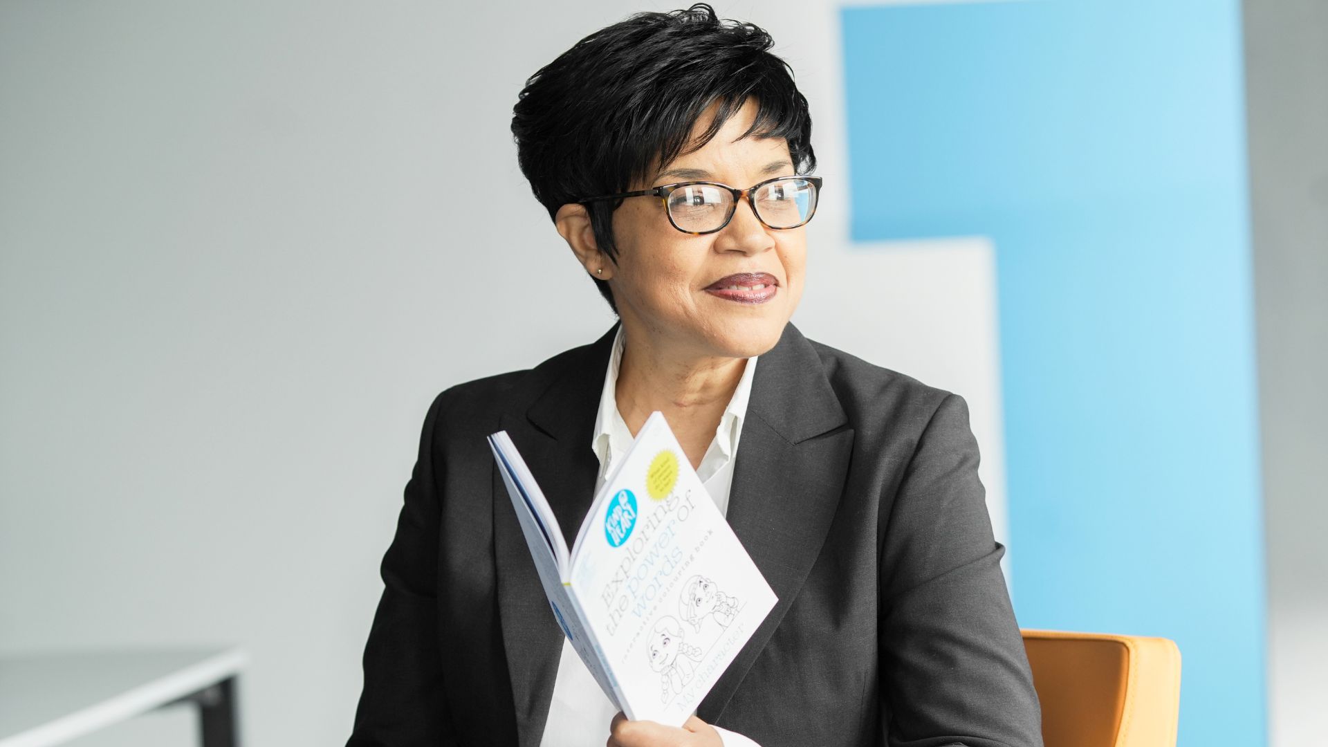 "Jacqueline proudly holds her newly published interactive children’s colouring book, Exploring the Power of Words: My Character, created to inspire confidence and self-worth in young readers."