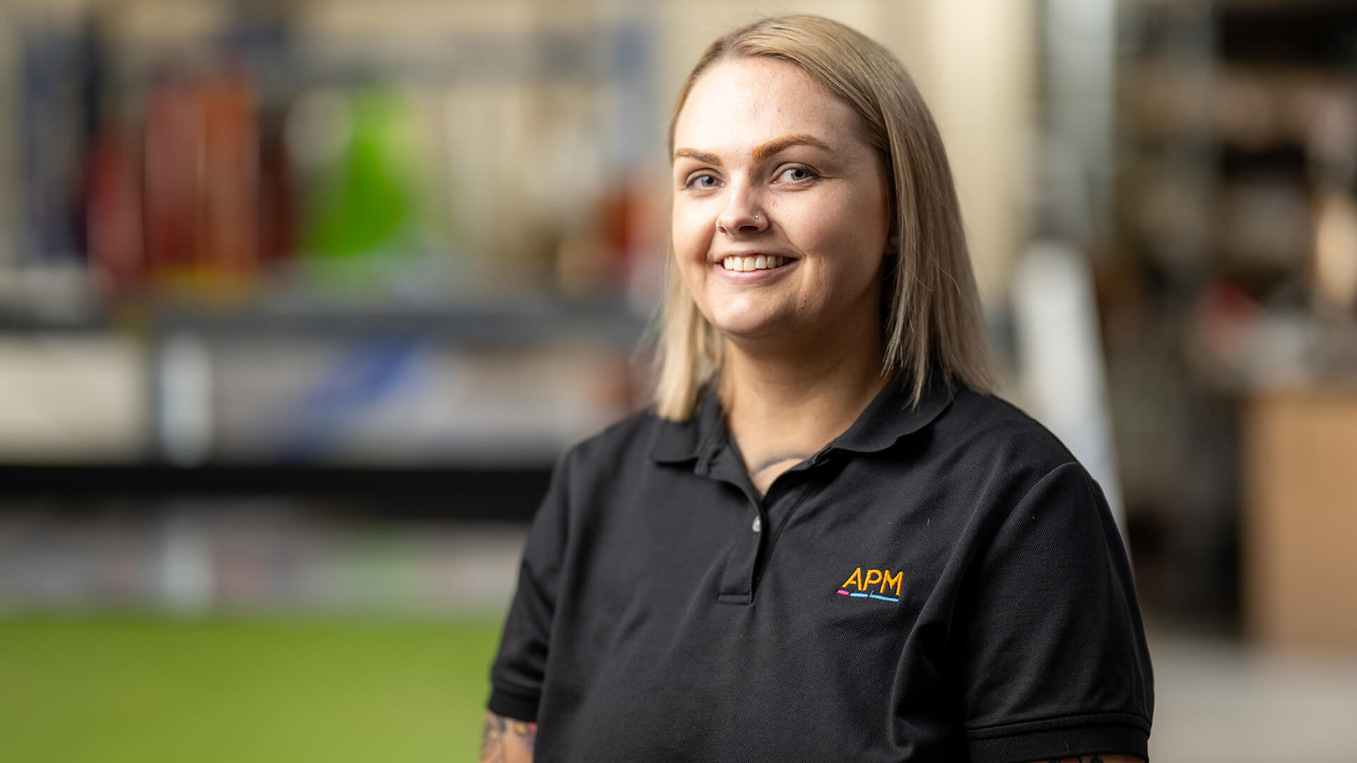 APM EC in black APM branded polo