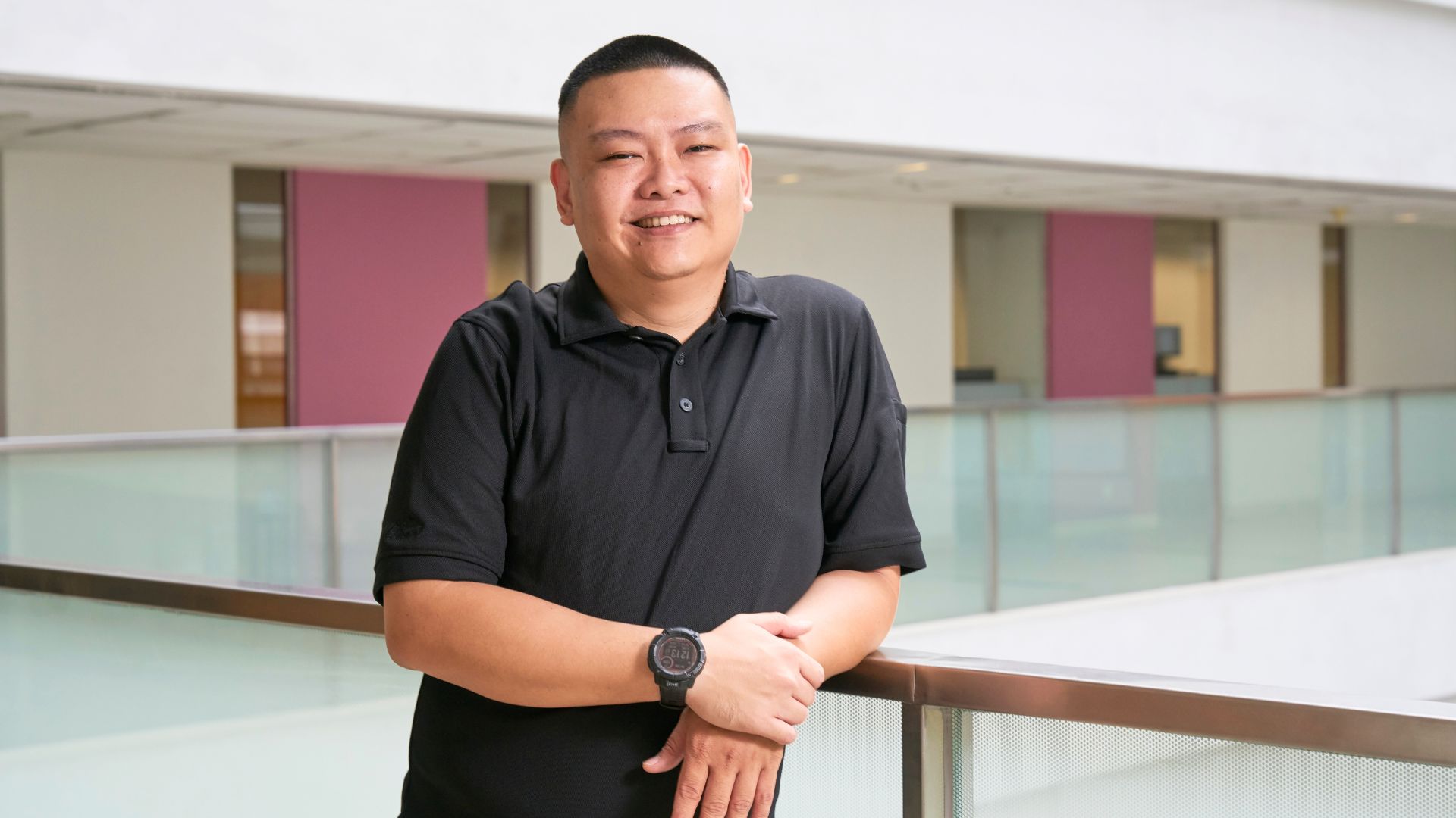 Joey standing in a modern office environment after successfully completing the Polaris program at Ingeus Singapore.