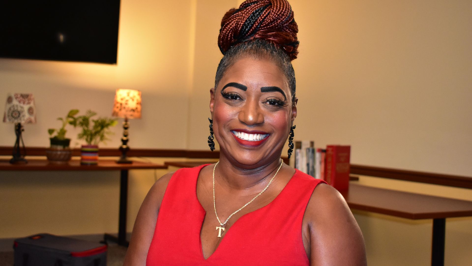 Latasha sitting in a conference room smiling