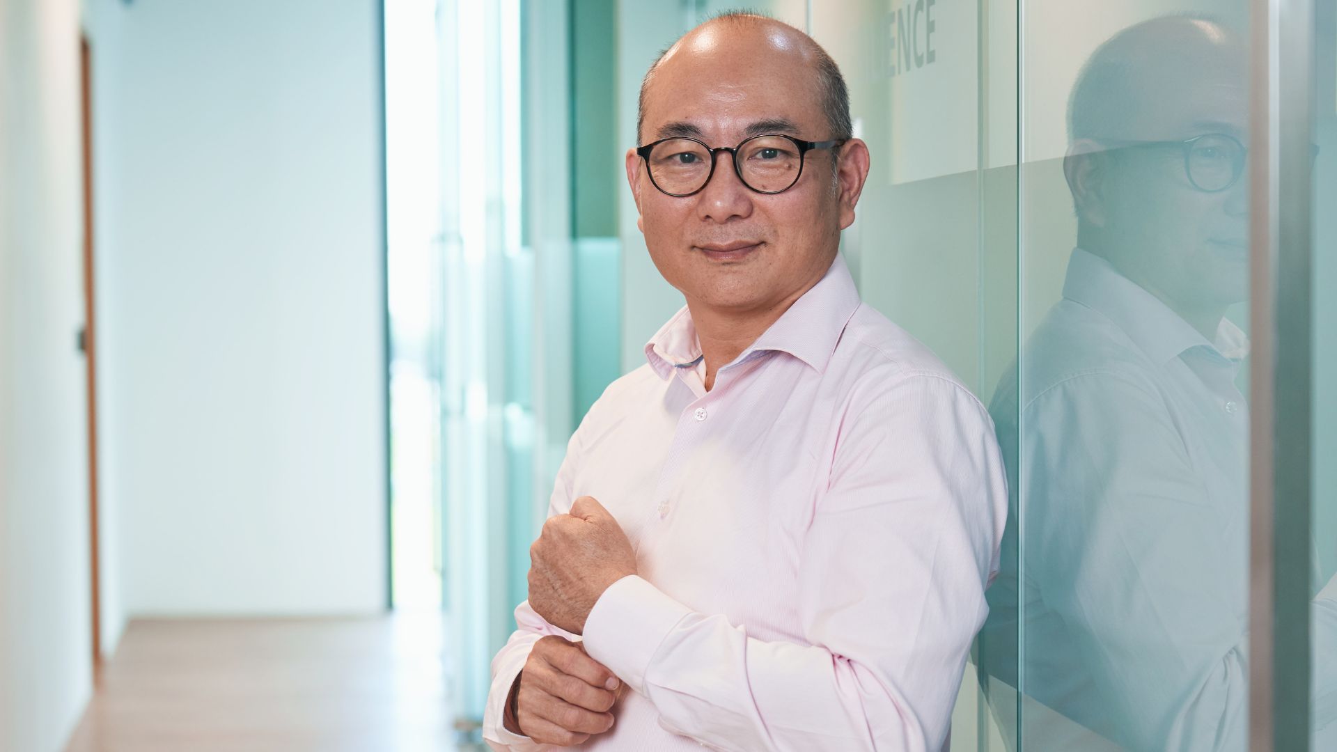 Enoch in a professional setting, symbolizing his achievement through the Polaris program at Ingeus Singapore.