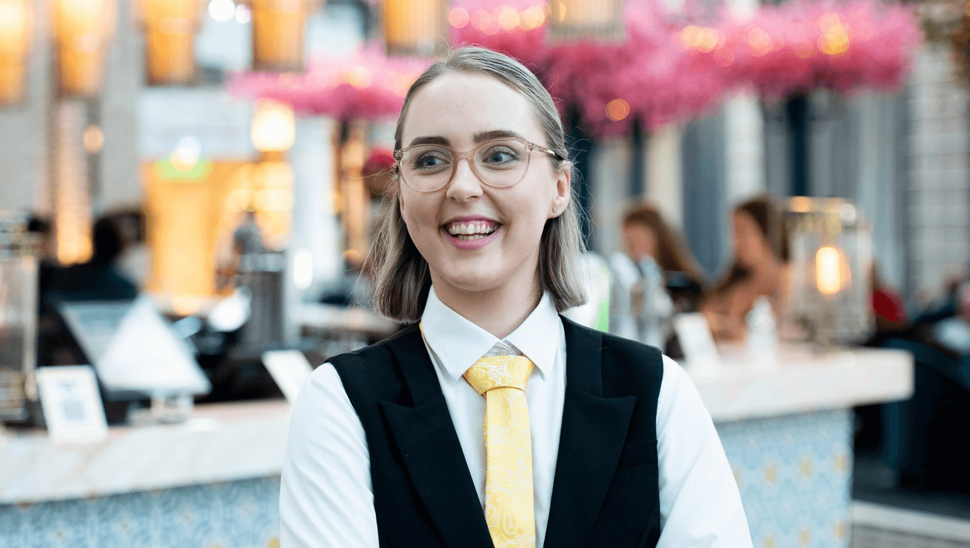 DES participant, Maegan, standing in the workplace smiling