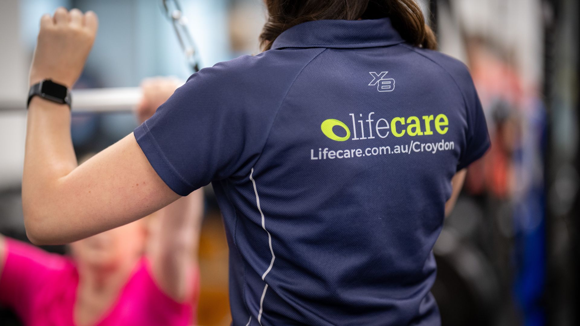 Close-up of a Lifecare Croydon team member wearing a branded uniform during a pilates session, reflecting the clinic’s professional environment.