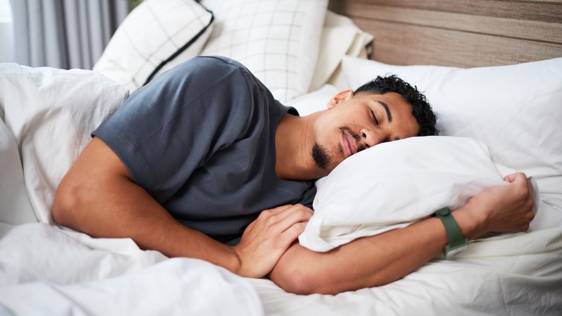 Young man peacefully sleeping in a comfortable bed