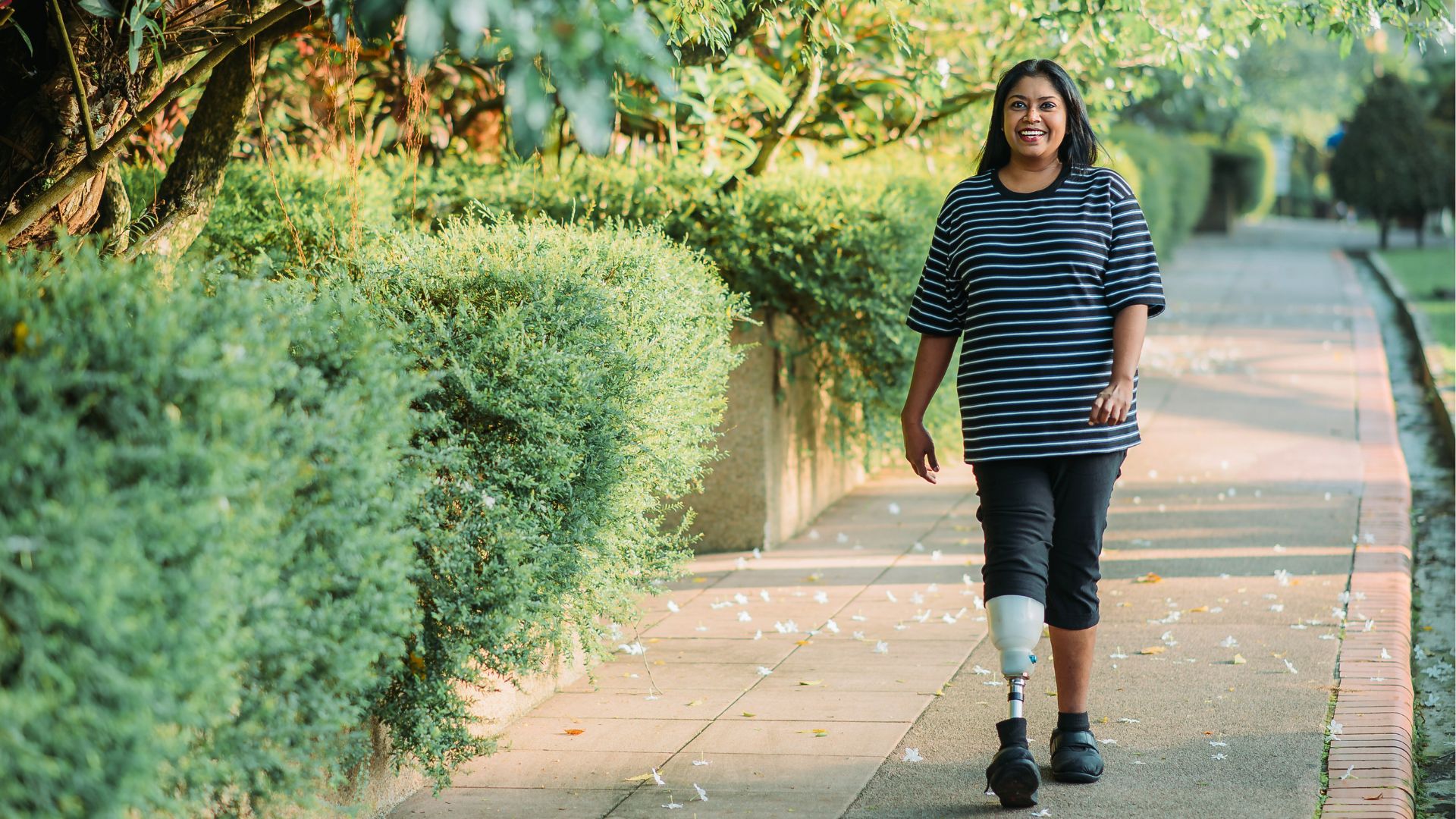 A person with a lower‑limb prosthesis walking along a footpath, illustrating independence and mobility while navigating eligibility and support options for the Disability Support Pension.