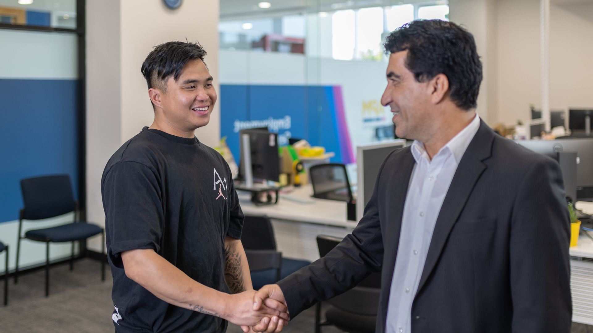 Workforce Australia participant shakes hands with a male APM manager