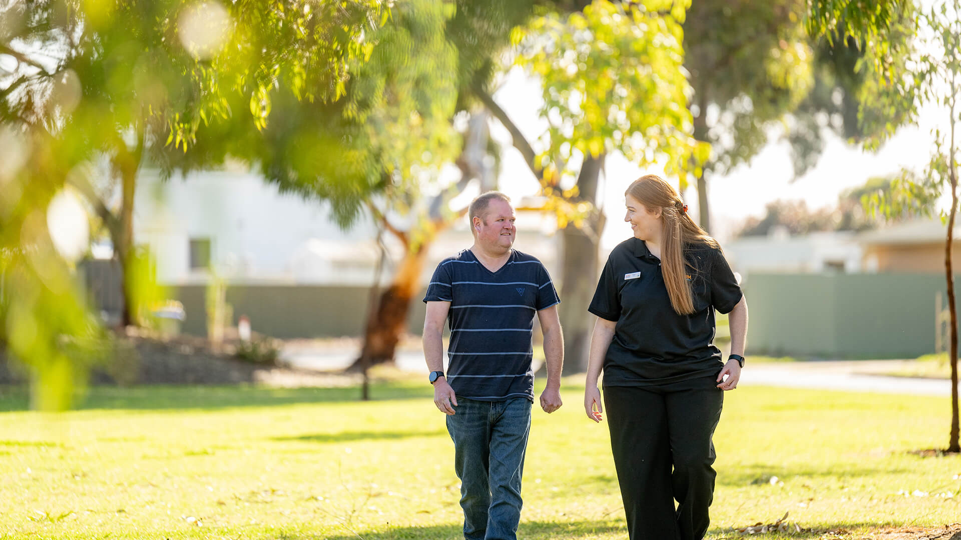 DES participant walking with an APM team member in a park