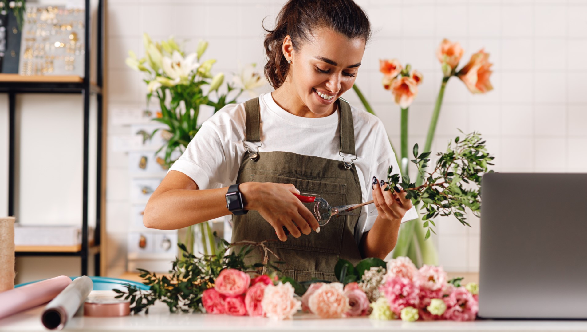 A smiling florist trimming flowers