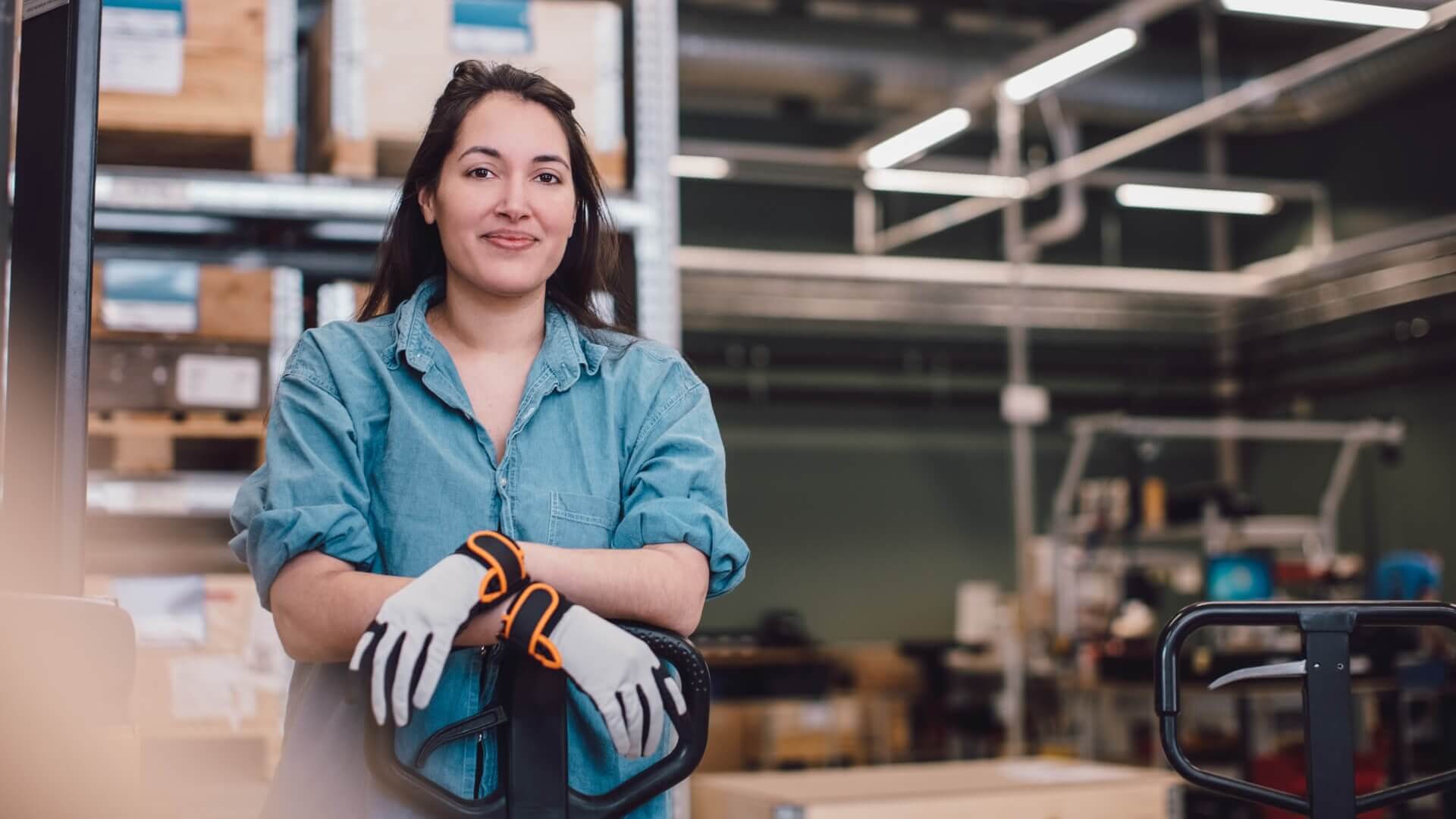 A warehouse worker standing in her workplace