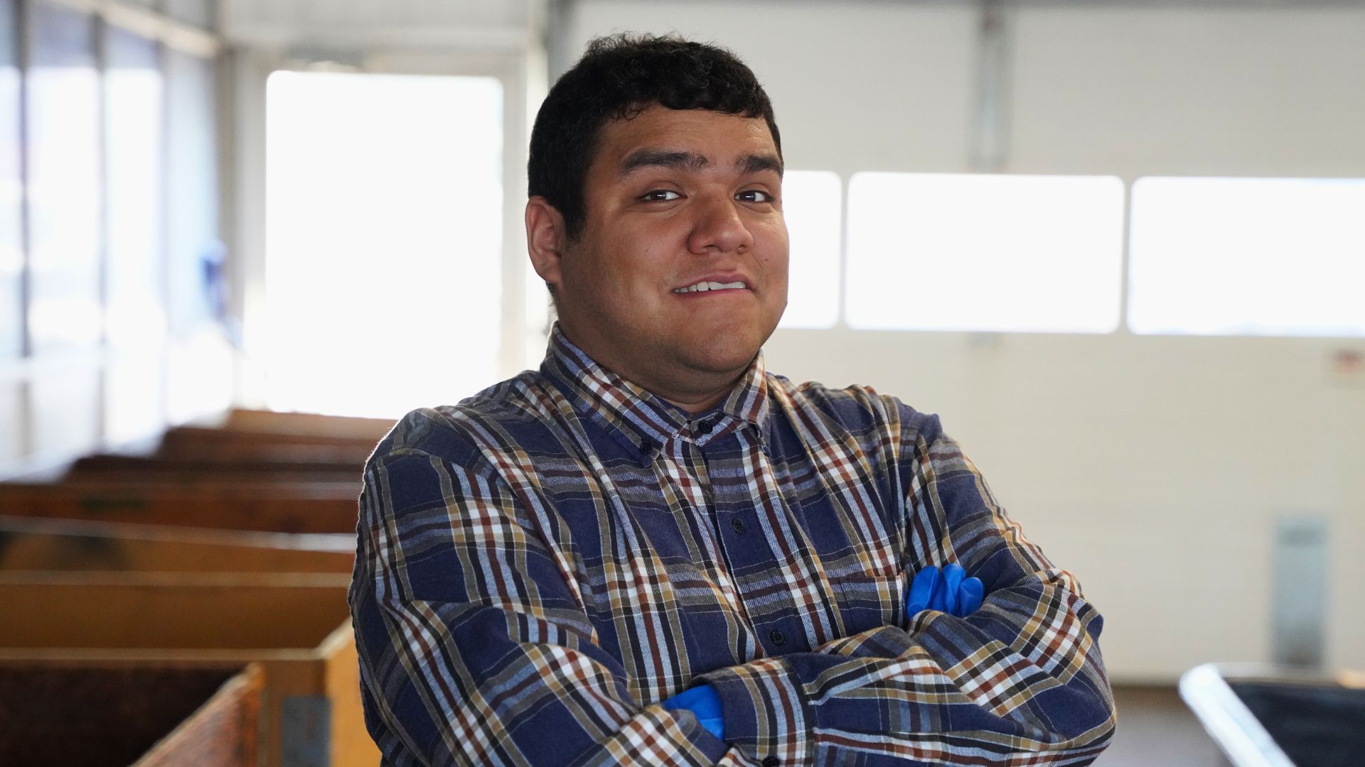 Jonathan smiles in a smart checkered shirt