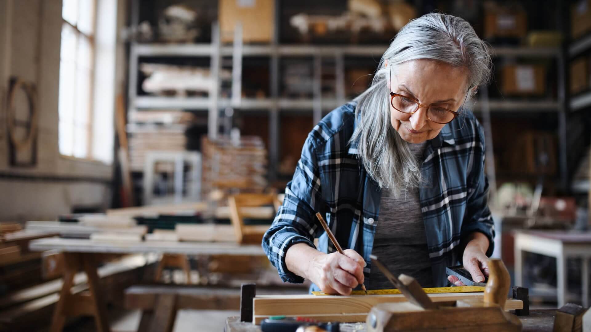 A woman working on a woodwork project