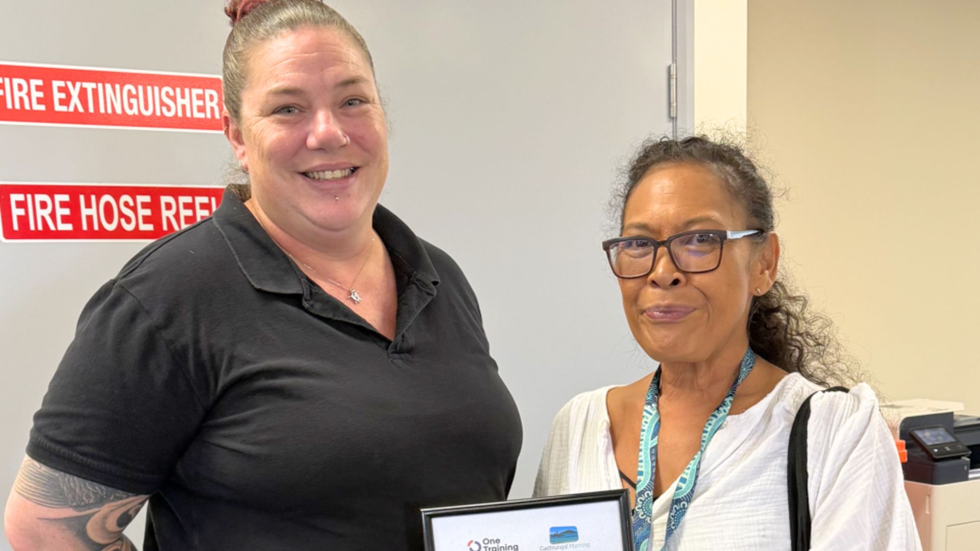 Phoebe stands with APM Employment Consultant Jade after finding work as an employment mentor