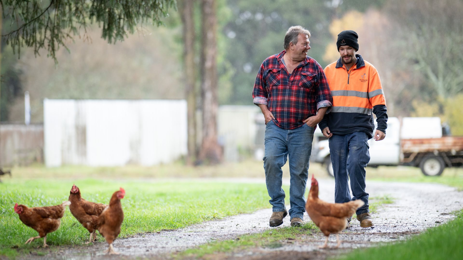 Angus and his father walk together on the family farm where Angus gained hands-on experience and confidence through practical work.