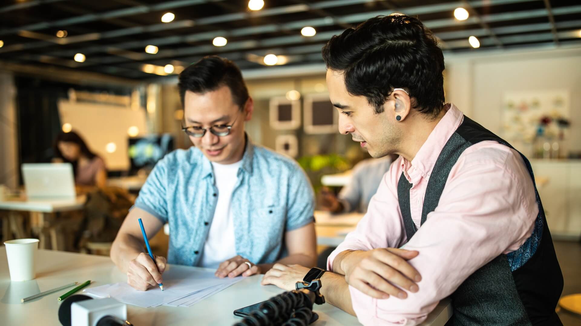 Two co-workers going over a document