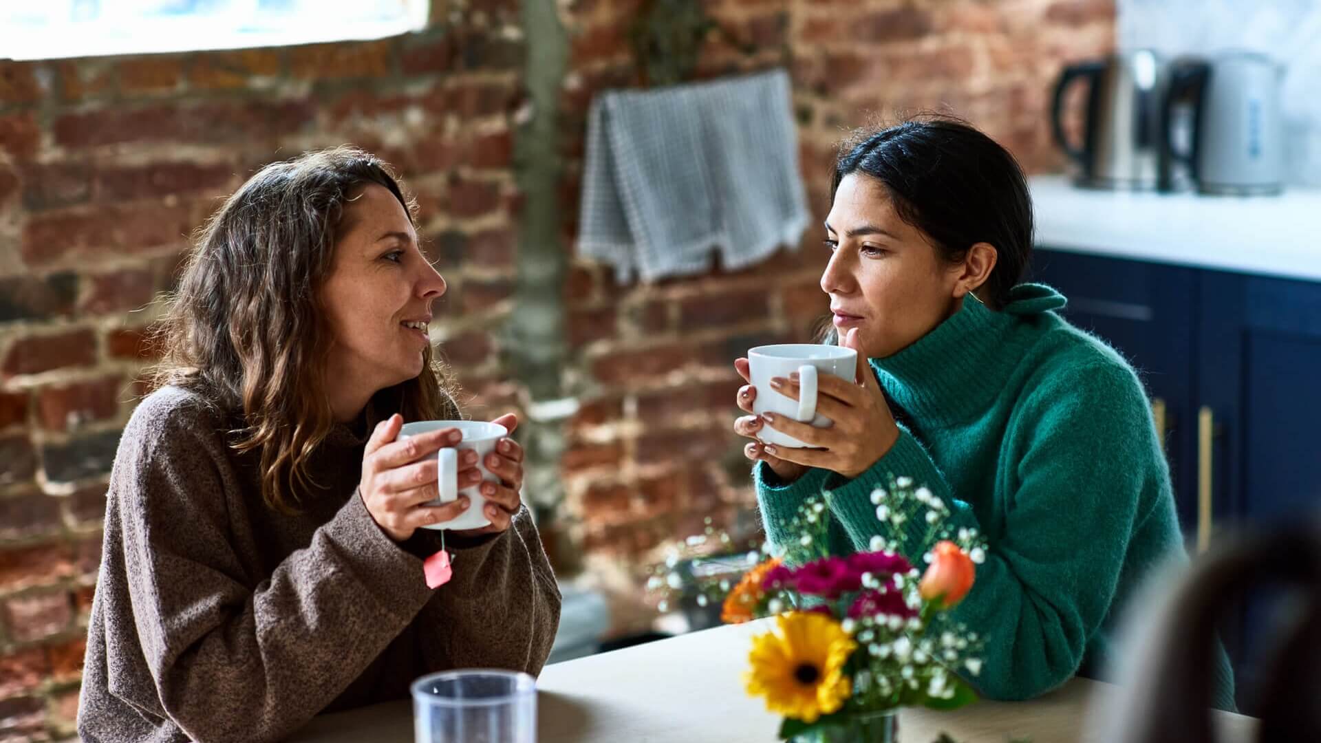 Two friends having a coffee in a cafe